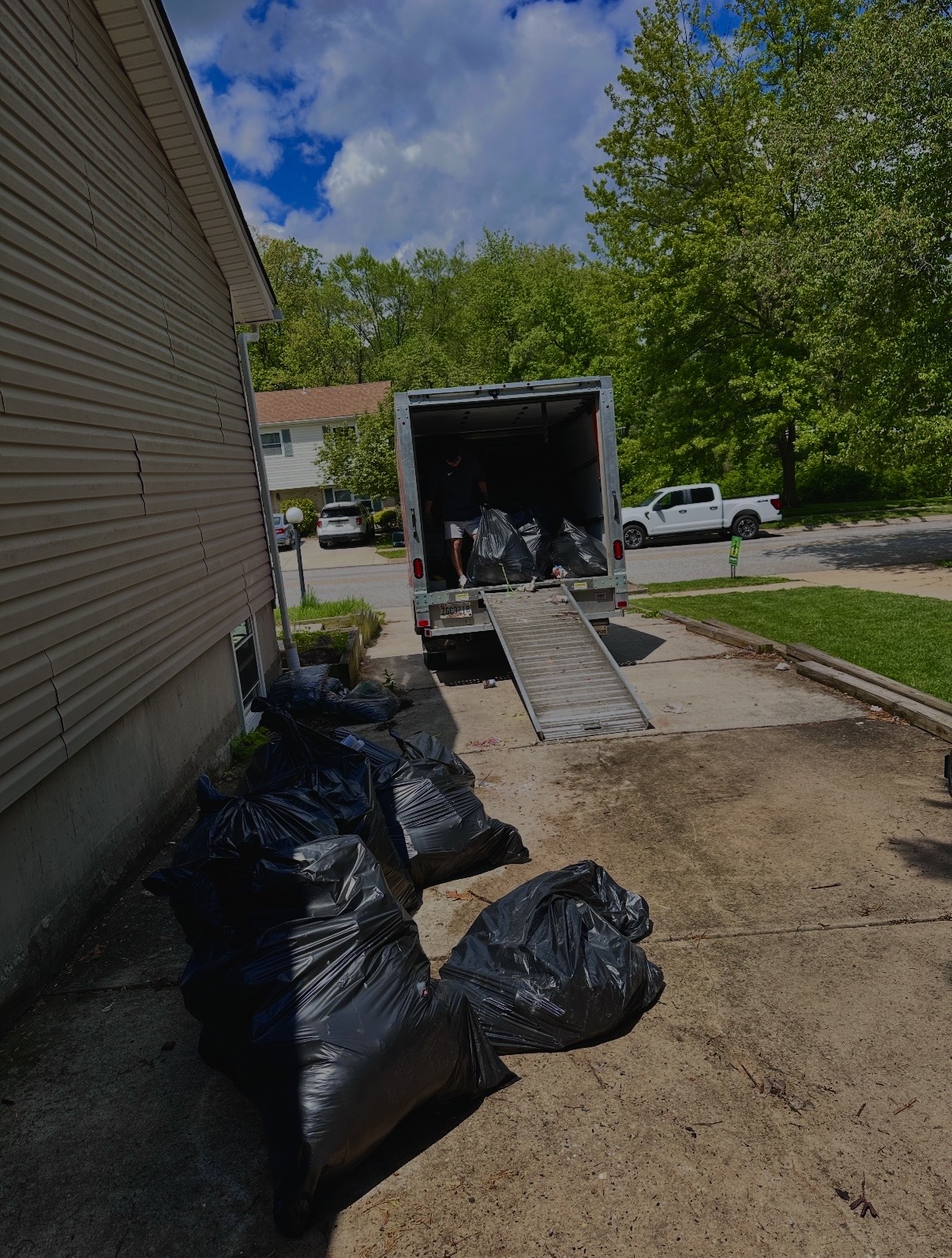 SwiftLift junk removal truck and team clearing a residential job